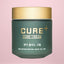 Cure Cream jar with gold lid on a pink background